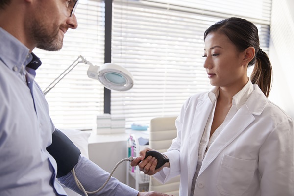 Male Patient Having pallative care Taken By Female Doctor In Office